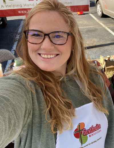 A young mother working at our market booth at The Butterbean Festival in Pinson, Alabama,